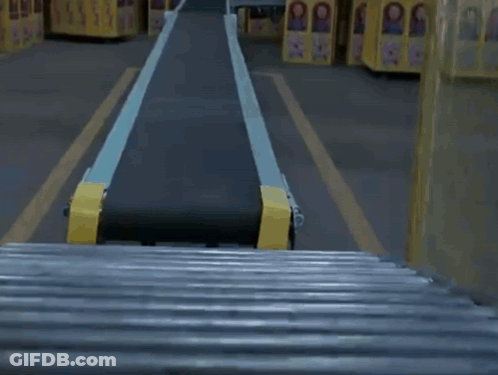 Child's Doll On Conveyor Belt In Factory GIF