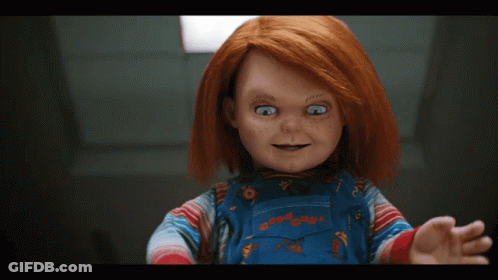 Child's Doll With Red Hair And Freckles In Overalls GIF