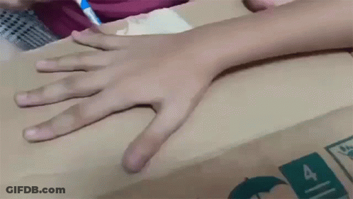 Child's Hand On Cardboard Box With Number 4 GIF