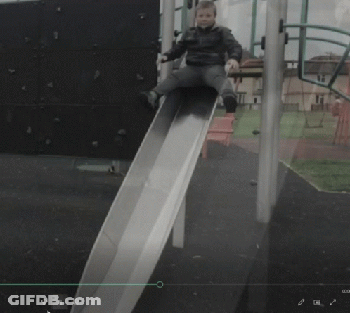 Child Sitting On Slide With Green Arrow GIF