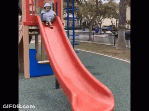 Child Sliding Down Red Slide GIF