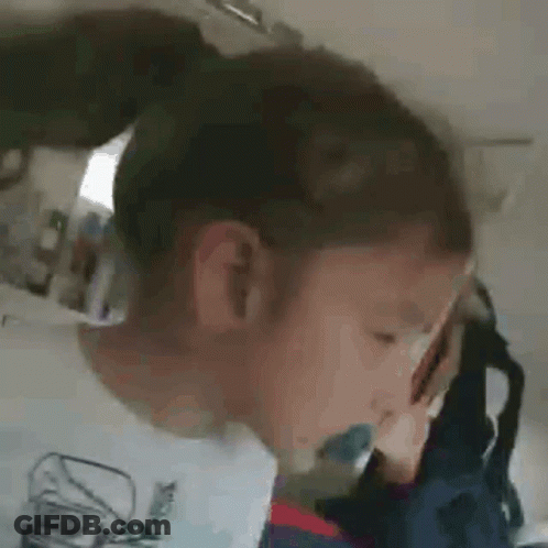 Child With Ponytail And Toothbrush In Mouth GIF