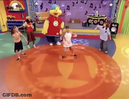 Children Dancing On Stage With Mascot Wearing H GIF