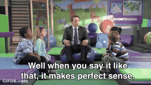 Children Sitting Around Man In Suit GIF