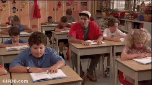 Children Sitting At Desks In Classroom GIF