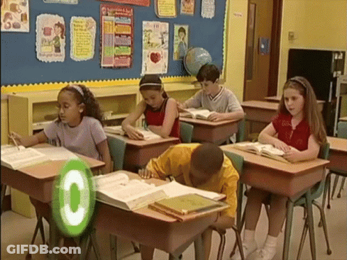 Children Sitting At Desks With Green Circle Saying C GIF
