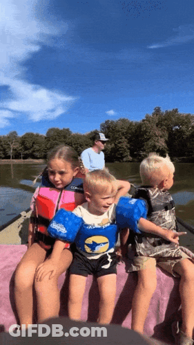 Children Sitting On Boat In Life Vests GIF