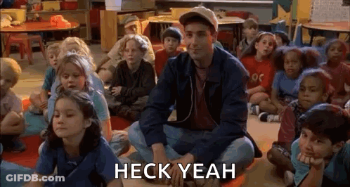 Children Sitting On Classroom Floor With Man GIF