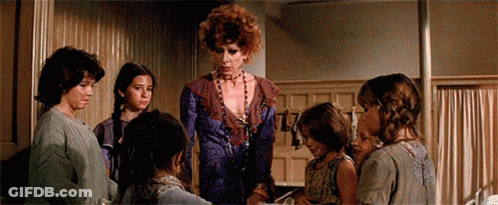 Children Standing Around Woman In Purple Dress GIF