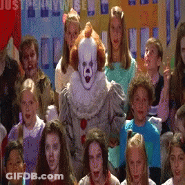 Children Standing In Front Of Clown Costume GIF