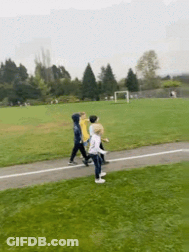 Children Walking Along Path In Field GIF