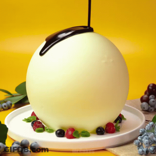 Chocolate Being Poured Over White Ball GIF