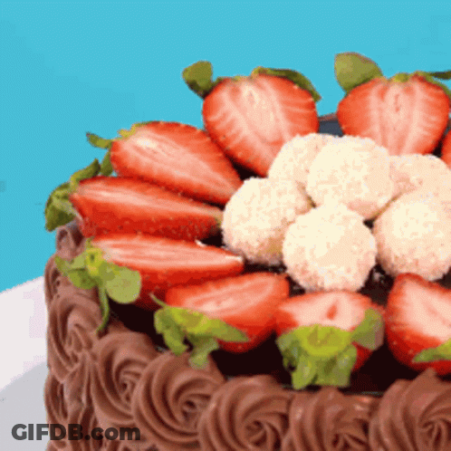 Chocolate Cake With Strawberries And Coconut Balls GIF