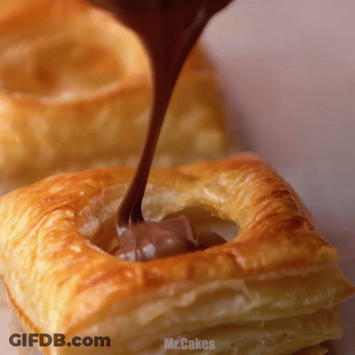 Chocolate Is Being Poured Into A Pastry That Says Mr.cakes On It GIF