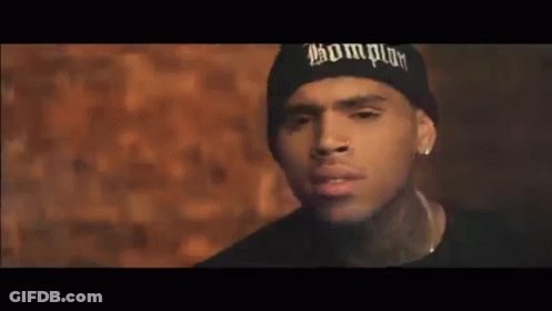 Chris Brown Is Wearing A Black Beanie And Earrings . GIF