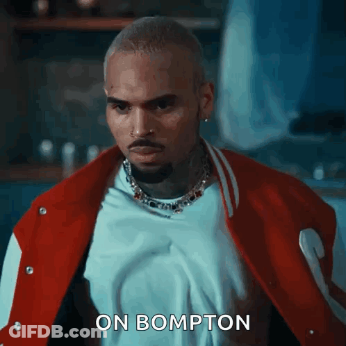 Chris Brown Is Wearing A Red And White Varsity Jacket And A White T-Shirt . GIF