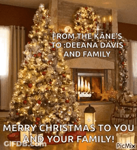 Christmas Card With Christmas Tree In Front Of Fireplace GIF