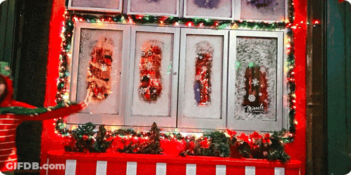 Christmas Display With Sign Saying Miracles GIF