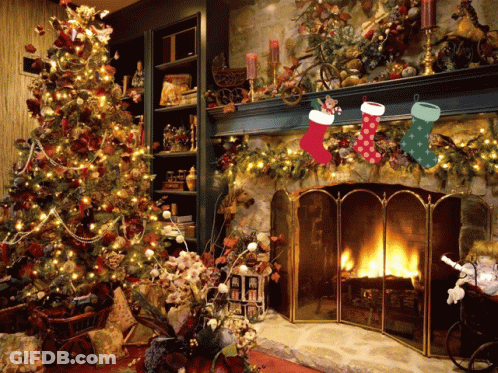 Christmas Stockings Hanging On A Mantle With A Fireplace In The Background GIF
