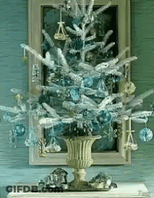 Christmas Tree With Blue Ornaments In Gold Vase GIF