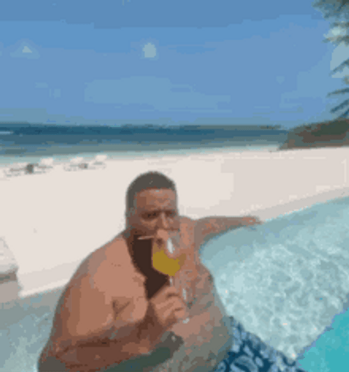 Chubby Man Drinking On A Beach GIF