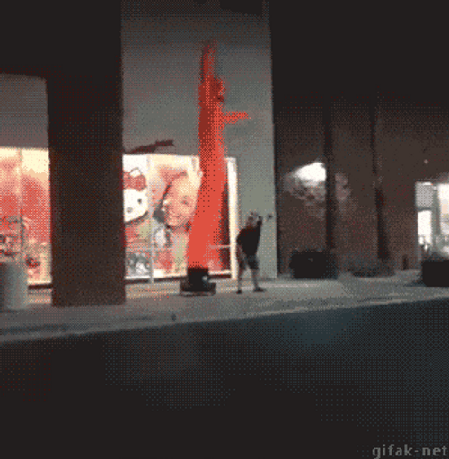 Chubby Man Mimicking Inflatable Tube Man Waves GIF