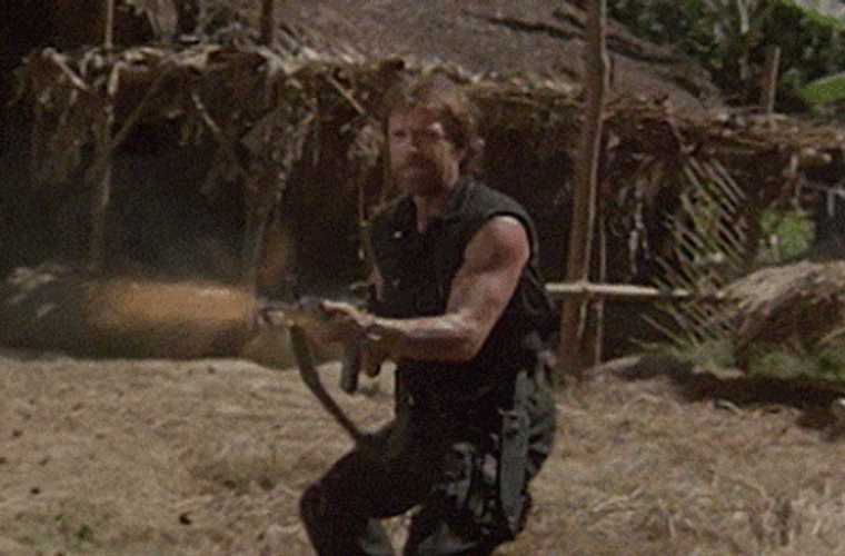 Chuck Norris Firing Machine Gun In Movie Scene GIF