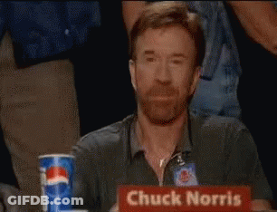 Chuck Norris Is Sitting At A Table With A Pepsi Can In Front Of Him GIF