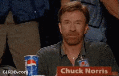 Chuck Norris Is Sitting At A Table With A Pepsi Can GIF