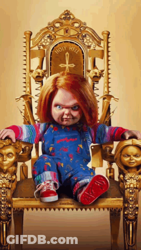 Chucky Doll On Gold Chair Saying Holy Hell GIF