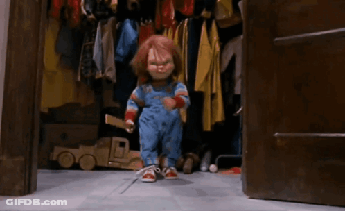 Chucky Doll Sitting On Ladder Holding Stick GIF