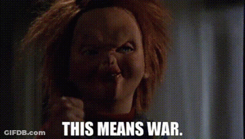 Chucky From Childs Play Is Making A Funny Face And Says `` This Means War '' . GIF
