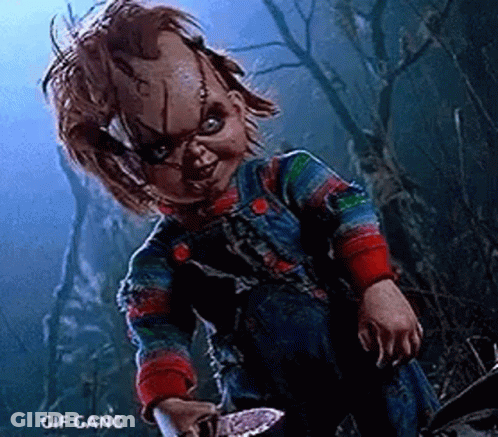 Chucky Holding Knife In Dark Forest GIF
