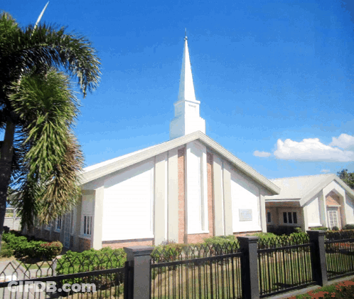 Church With Steeple And Sign Saying Jesus GIF
