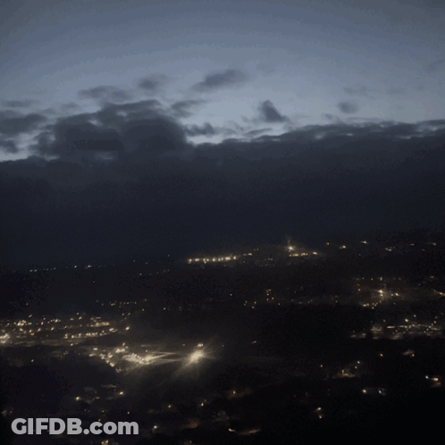 City At Night With Cloudy Sky GIF
