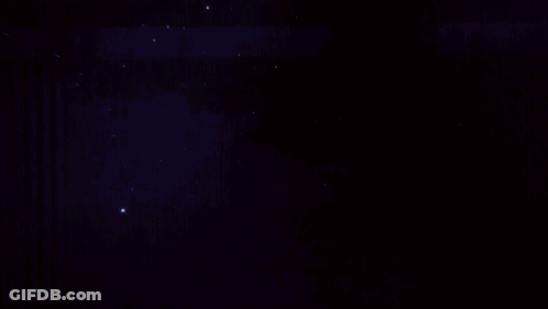 City At Night With Green Light From Sky GIF