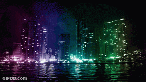 City Skyline At Night With Green And Purple Lights Reflected In Water GIF