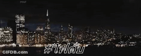 City Skyline Lit Up At Night With Foreign Language GIF