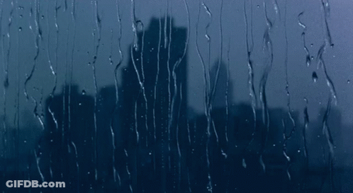 City Skyline Through Rainy Window GIF