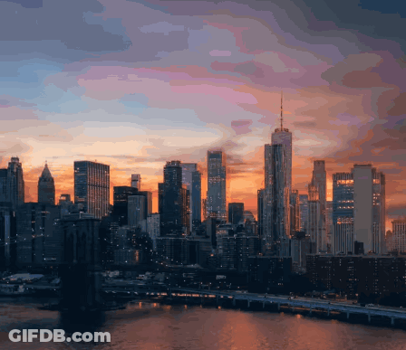 City Skyline With Bridge And Sunset GIF
