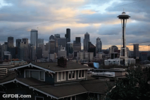 City Skyline With Houses And Space Needle GIF