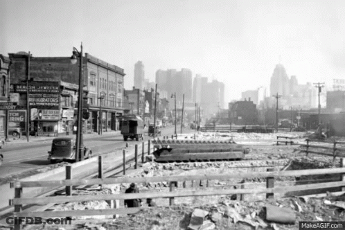 City Street With Fence And New Ring Sign GIF