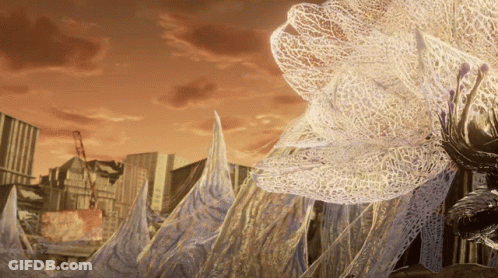 City With Large White Flower In Foreground GIF