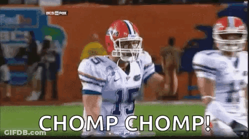 Clemson Football Players In Orange Uniforms With Trophy GIF
