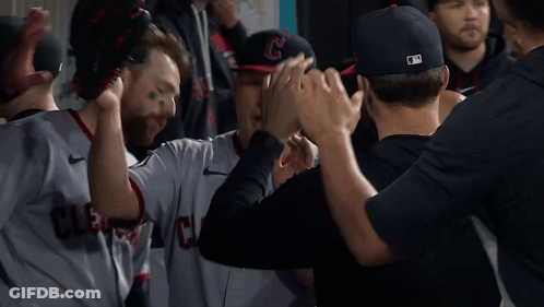 Cleveland Baseball Players High Five In Dugout GIF