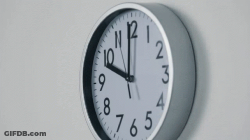 Clock On White Wall Showing Almost Eleven GIF