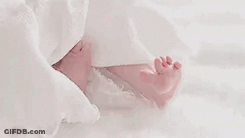 Close Up Baby's Feet On White Blanket GIF