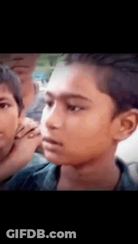 Close Up Boy Face With Group Behind GIF