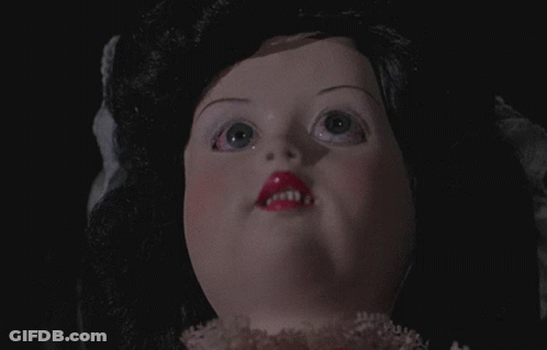 Close-Up Doll Face With Black Hair And Pink Lips GIF