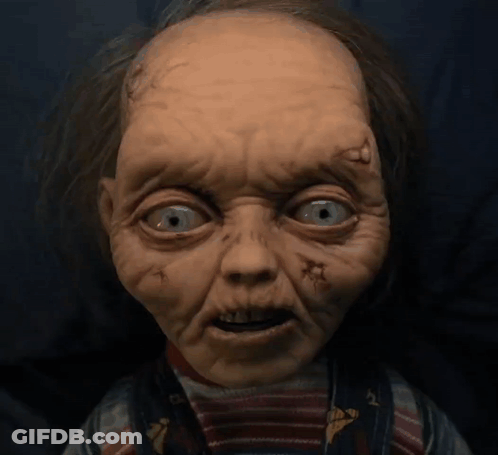 Close Up Doll Face With Holes In Eyes GIF